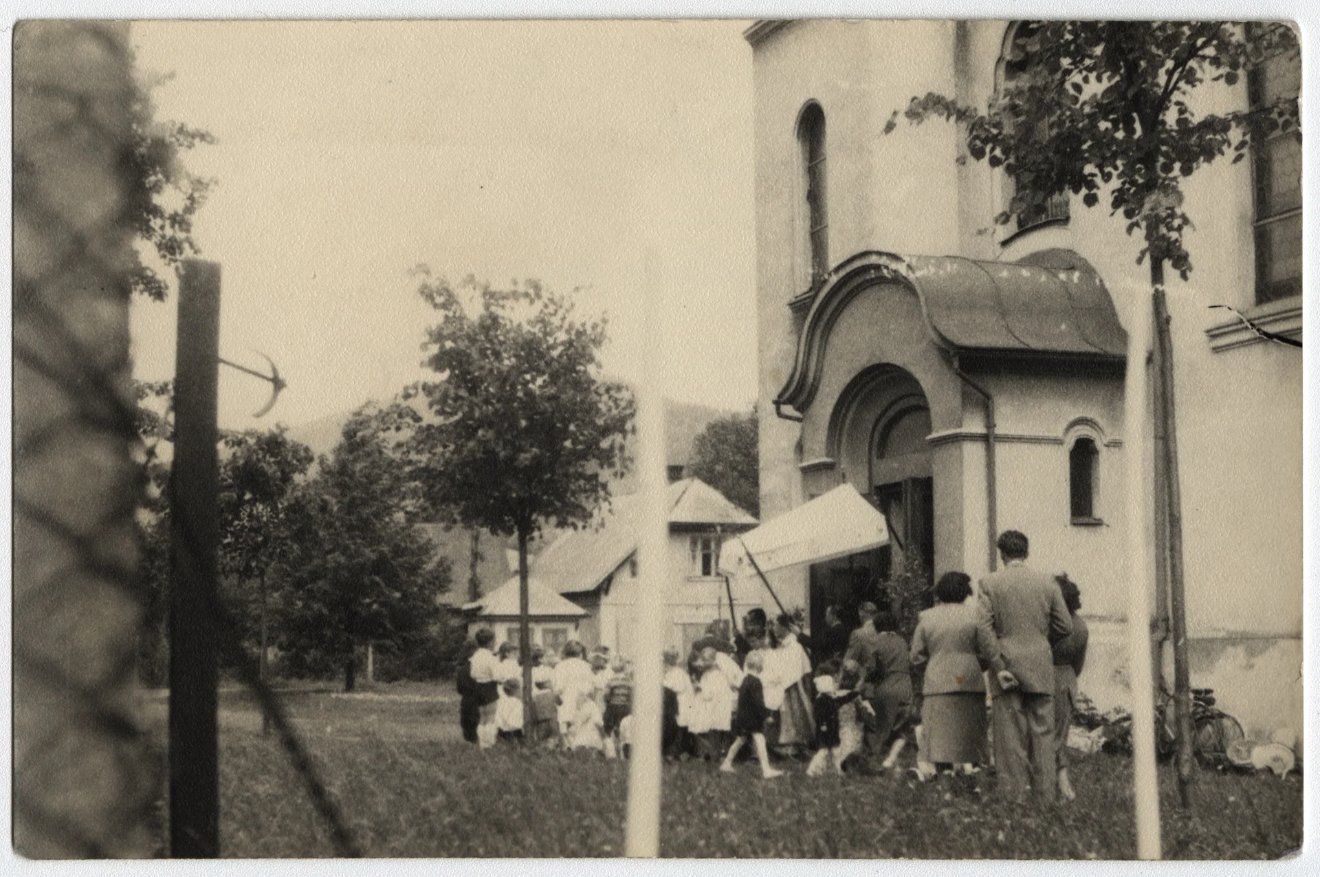 Náhledový obrázek předmětu Procesí u brány kostela v České Vsi, 60. léta 20. století (amatérská fotografie)
