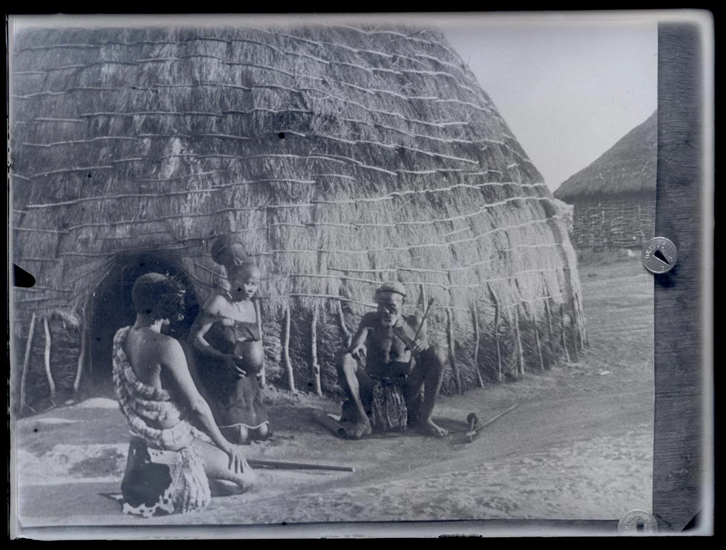 Náhledový obrázek předmětu Rodina před tradičním africkým kruhovým obydlím - chýší.